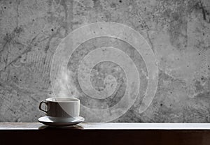 Cup of hot drinks with steam on wood table and concrete background, hot coffee, tea, chocolate and etc. photo
