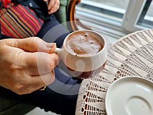 A cup of hot and foamy Turkish coffee