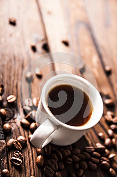 Cup of hot fresh black coffee on vintage wooden table