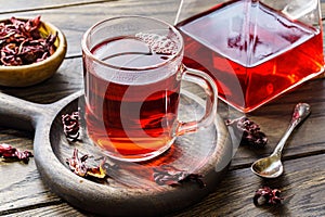 Cup of hot hibiscus tea on table