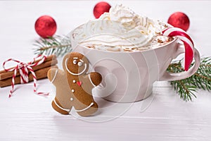 Cup of hot homemade chocolate drink with whipped creamand gingerbread cookies for christmas holiday.