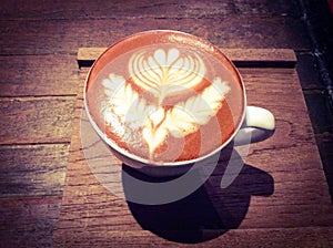 Cup of hot latte or cappuccino with fascinating latte art photo