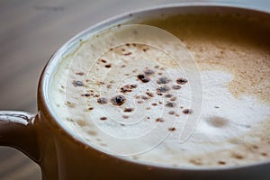 A cup of hot latte,coffee art on the wooden table in relex time