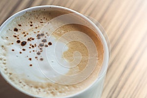 A cup of hot latte,coffee art on the wooden table in relex time