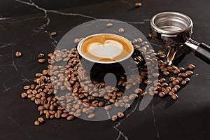 Cup of hot latte coffee with beautiful milk foam latte art texture with coffee bean on black marble background. Overhead