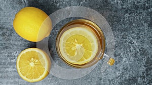 A cup of hot lemon tea on concrete table