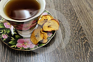 A Cup of hot tea with dried fruits on a table