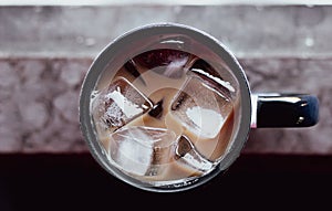 Cup of iced coffee on old wood