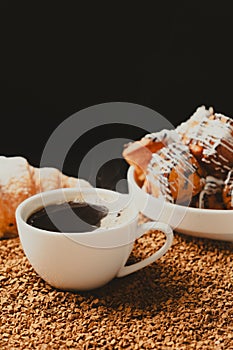 A cup of instant coffee granules and scones. Beautiful and delicious breakfast.