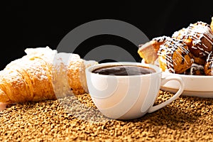 A cup of instant coffee granules and scones. Beautiful and delicious breakfast.