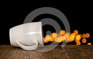 Cup lay on side on wood with round shape bokeh