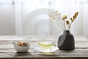 A cup of Lemongrass and Pandanus leaf herb with dry flower in clay pot