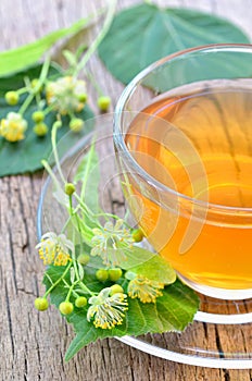 Cup with linden tea and flowers