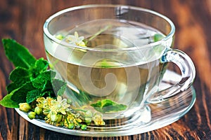 Cup of linden tea on wooden table still life