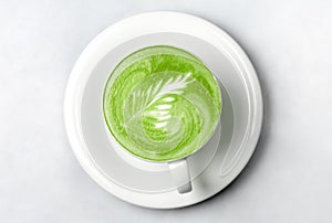 Cup of matcha green tea latte over white photo