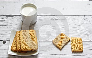 Cup of milk and cookie on a wooden background. Healthy breakfast