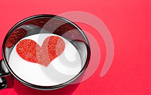 Cup of milk with decorative heart on red background, concept of valentine day