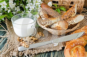 Cup of milk with fresh pastries and nuts