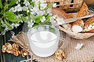Cup of milk with fresh pastries and nuts