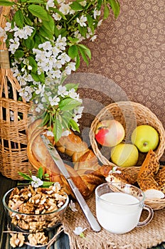 Cup of milk with fresh pastries and nuts