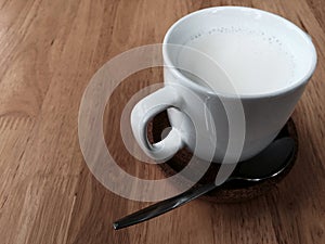 A cup of milk on the wood table