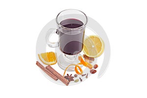 Cup of mulled wine and mulling spices on light background