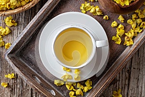 A cup of mullein tea with fresh verbascum, top view