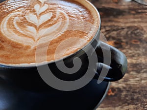 A cup off coffee latte on wooden table
