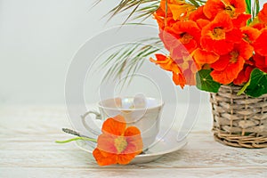 Cup and orange flowers