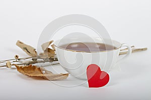 Cup of oriental teawith red heart tag on white background