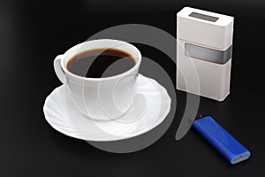 Cup os coffee. Cigarettes and lighter.