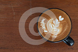 A cup of Piccolo Latte art  on wooden desk, Relaxing time or coffee`s break time during work day