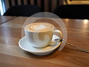 A cup of professionally prepared latte on a table in a cafe photo