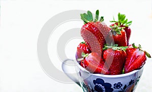 Cup of red strawberries for breakfast on white background