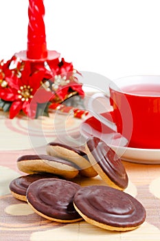 Cup of red tea, chocolate cookies and candle