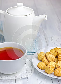 A cup of redbush tea with tiny shortbread cookies