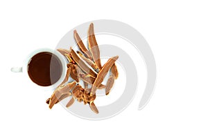 Cup of reishi tea and dried Lingzhi mushroom on white background.