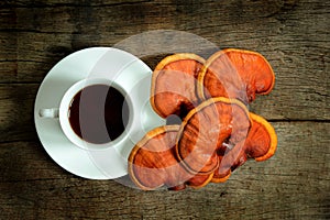 Cup of reishi tea and fresh Lingzhi mushroom.