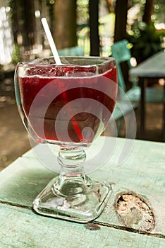 Cup with Rosa de Jamaica drink on outdoor table, restaurant in Guatemala, Central America. photo