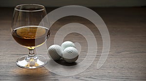 CUP OF RUM WITH GOLF BALLS ON HIGH CONTRAST