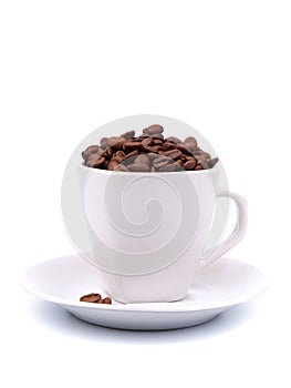 Cup and saucer with coffee beans