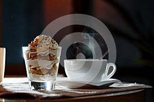 Cup, saucer, spoon and dessert in a glass