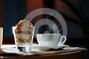 Cup, saucer, spoon and dessert in a glass