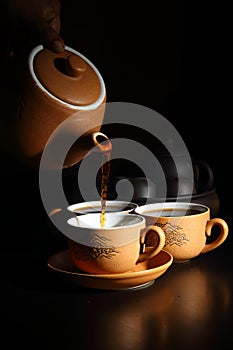Cup and saucer with teapot