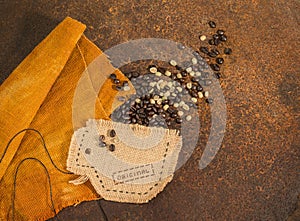 A cup sewn in jute full of coffee beans.