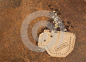 A cup sewn in jute full of coffee beans.