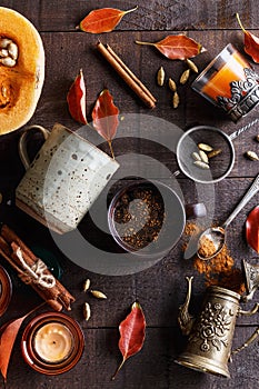 Cup of spiced coffee over dark rustic background