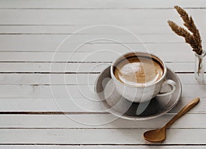 Cup of tasty coffee on white wooden cafe table