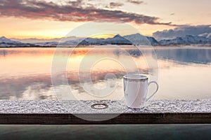 A cup of tea with a beautiful scenery in the background