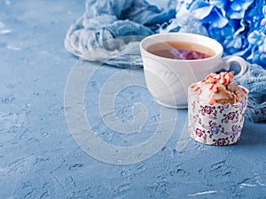 Cup of tea on blue background with flowers